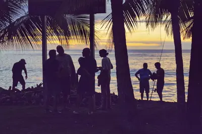 a group of people standing on the beach looking at the ocean at Casa Kimara in Uvita