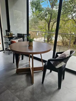 a table and a chair in a room with a window at Mystica in Playa Avellana