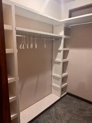 a walk in closet with white shelves at Tivives Kikala Lodge 2 in Puntarenas