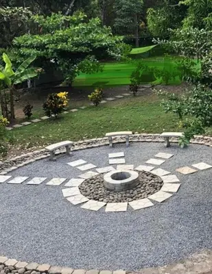 a stone patio with a bench and a fire place at Tivives Kikala Lodge 2 in Puntarenas