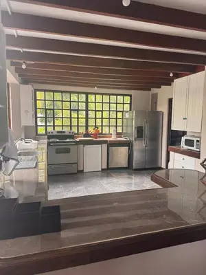 a large kitchen with stainless steel appliances at Tivives Kikala Lodge 2 in Puntarenas