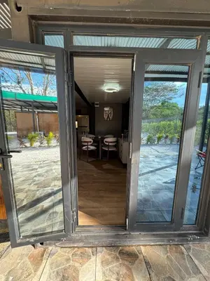 a sliding glass door leading to a dining room at Casa Bolsero - private, small home in Tamarindo in Tamarindo