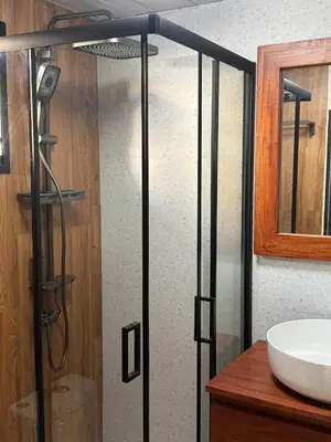 a shower with a glass door next to a sink at Casa Bolsero - private, small home in Tamarindo in Tamarindo