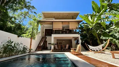 a villa with a swimming pool and a house at Casa Joy - 3 Apartment Villa in the Hills of Santa Teresa in Santa Teresa Beach
