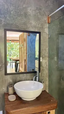 a bathroom with a sink and a large mirror at Casa Joy - 3 Apartment Villa in the Hills of Santa Teresa in Santa Teresa Beach