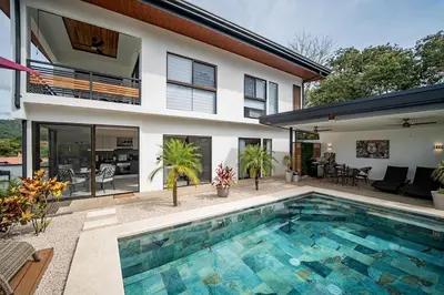 a house with a swimming pool in front of a house at Casa Vineta, Apartment in Duplex, close to beach in Carrillo