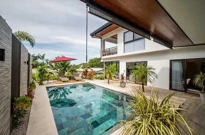 a swimming pool in the backyard of a house at Casa Vineta, Apartment in Duplex, close to beach in Carrillo