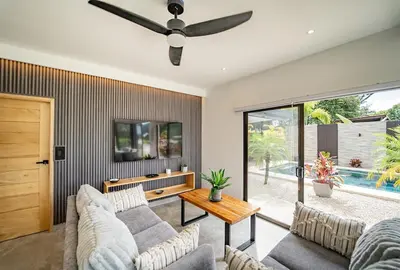 a living room with a couch and a ceiling fan at Casa Vineta, Apartment in Duplex, close to beach in Carrillo
