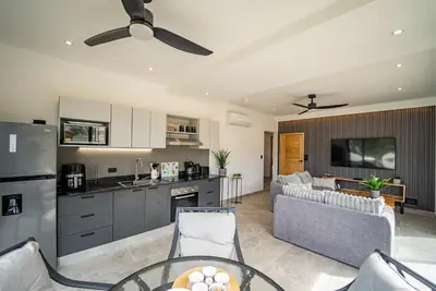 a kitchen and living room with a couch and a table at Casa Vineta, Apartment in Duplex, close to beach in Carrillo