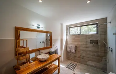 a bathroom with a sink and a mirror and a shower at Casa Vineta, Apartment in Duplex, close to beach in Carrillo