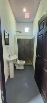 a bathroom with a toilet and a sink and a shower at Abacaxi Hostel in Santa Teresa Beach