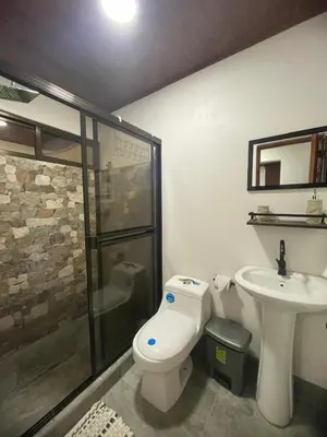 a bathroom with a toilet and a sink at Apartamento Playa Sámara in Sámara