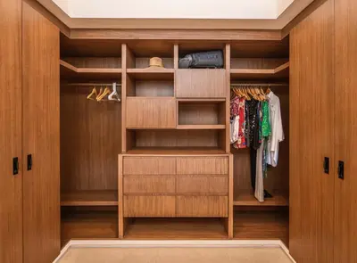 a walk in closet with wooden doors and shelves at Nimbu Vida in Tamarindo