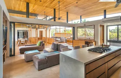 an open kitchen and living room with a large island at Nimbu Vida in Tamarindo