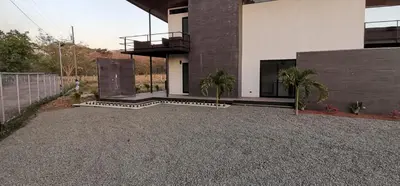 a house with a gravel driveway in front of it at Playa Potrero in Potrero