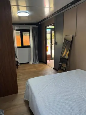 a bedroom with a white bed and a sliding glass door at Casa Mosquero - lovely 1 bedroom home in Tamarindo - private and serene in Tamarindo