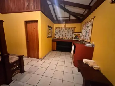 a bathroom with yellow walls and a table and a sink at 2BR Toucans and Waterfalls- the garden cottage in Caña Blanca