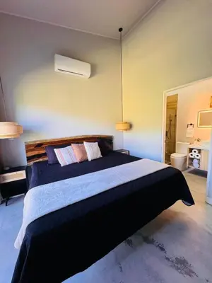 a bedroom with a large bed in a room at Blue Zone Private Eco Residence - Essence Suite - in Tamarindo
