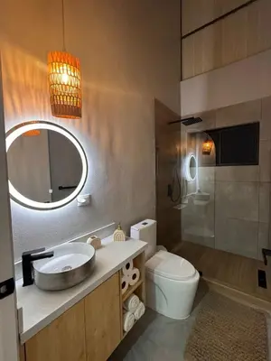 a bathroom with a sink and a toilet and a mirror at Blue Zone Private Eco Residence - Essence Suite - in Tamarindo