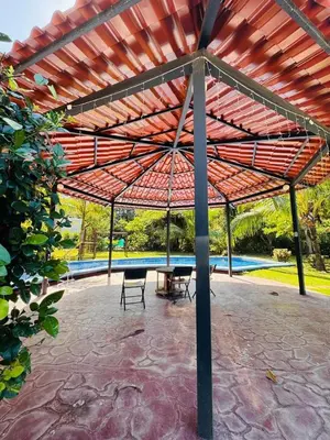 a pavilion with a table and chairs under a roof at Blue Zone Private Eco Residence - Essence Suite - in Tamarindo