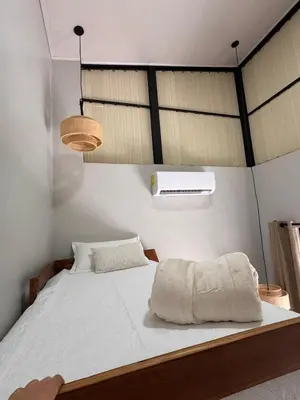 a bedroom with a large bed with white sheets at Blue Zone Private Eco Residence - Essence Suite - in Tamarindo