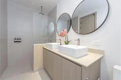 a bathroom with two sinks and a mirror at Brisa Mar, Ocean Views, Beach Club & Pools in Sardinal