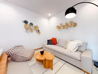 a living room with a couch and a table at Sunset Terrace at Naumi, Ocean Views & Beach Club in Sardinal