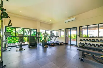 an empty gym with a lot of exercise equipment at Sunset Terrace at Naumi, Ocean Views & Beach Club in Sardinal