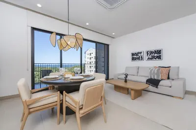 a living room with a table and a couch at Vista Paz Condo, Ocean Views & Beach Club in Sardinal