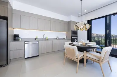 a kitchen and dining room with a table and chairs at Vista Paz Condo, Ocean Views & Beach Club in Sardinal