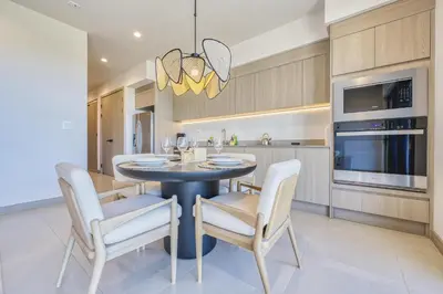 a kitchen and dining room with a table and chairs at Vista Paz Condo, Ocean Views & Beach Club in Sardinal