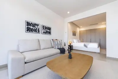 a living room with a couch and a bed at Vista Paz Condo, Ocean Views & Beach Club in Sardinal