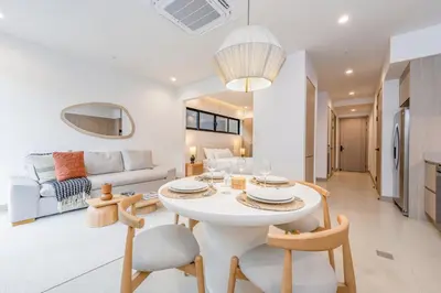 a white living room with a white table and chairs at Pacific Valley at Naumi, Beach Club, Gym, Pools in Sardinal