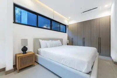 a bedroom with a large white bed and a window at Pacific Valley at Naumi, Beach Club, Gym, Pools in Sardinal