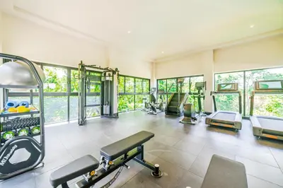 a gym with several treadmills and machines at Pacific Valley at Naumi, Beach Club, Gym, Pools in Sardinal