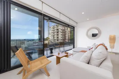 a living room with a white couch and a large window at Casa Matcha, BRAND NEW! Ocean Views & Beach Club in Sardinal
