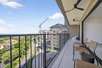 a balcony with a view of a building at Tropics at Naumi, Ocean Views, Gym & Pools in Sardinal