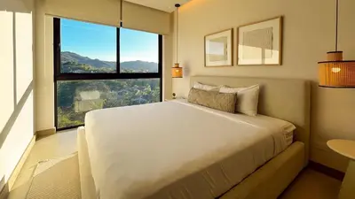 a bedroom with a large bed and a large window at Costa Azul Condo, Ocean View & Beach Club in Sardinal