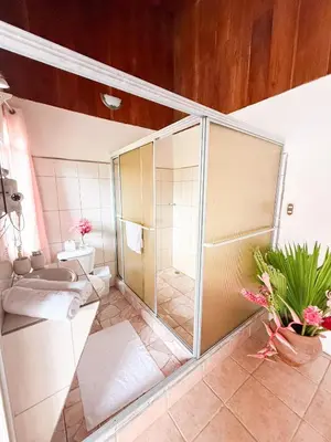 a bathroom with a glass shower with a toilet at Selva Partners La Fortuna in Guaria