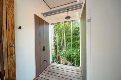 a hallway with a door leading to a forest at Casa Bromelia in Portalón
