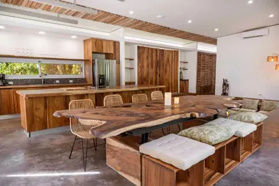 a kitchen with a large wooden table and chairs at Casa Bromelia in Portalón