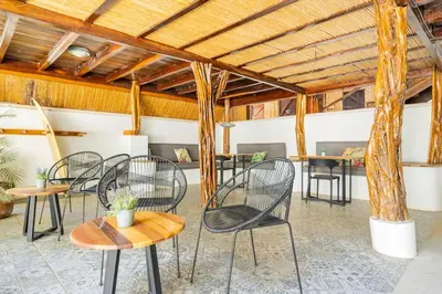 a group of chairs and tables in a room at La Buena vida Cabina 1 in Playa Grande