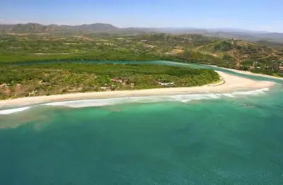 an aerial view of a beach and the ocean at La Buena vida Cabina 1 in Playa Grande
