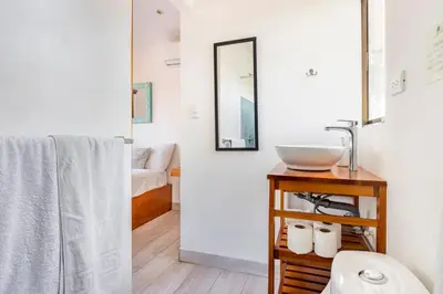 a bathroom with a sink and a mirror at La Buena vida Cabina 1 in Playa Grande
