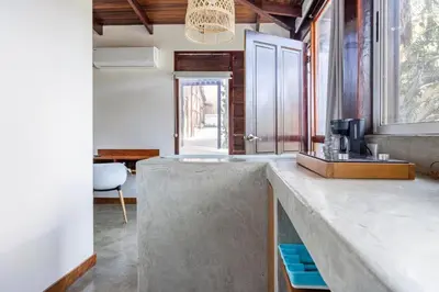 a kitchen with a concrete counter top and a sink at La Buena vida Cabina 4 in Playa Grande