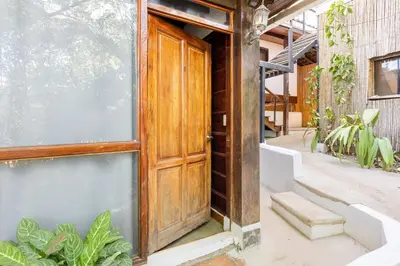 an open wooden door in a building with plants at La Buena vida Cabina 4 in Playa Grande