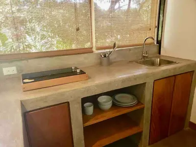 a kitchen counter with a sink and a window at La Buena vida Cabina 4 in Playa Grande