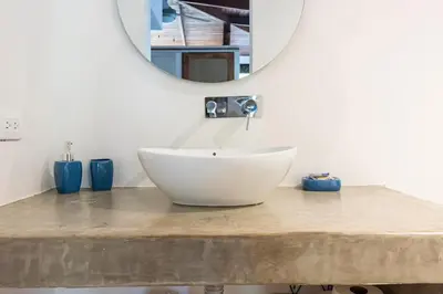 a bathroom with a white sink and a mirror at La Buena vida Cabina 4 in Playa Grande