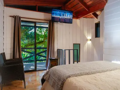 a bedroom with a bed and a tv on the wall at Nido de Montaña in Fraijanes