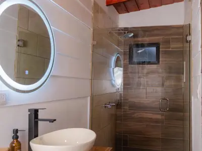 a bathroom with a sink and a shower at Nido de Montaña in Fraijanes